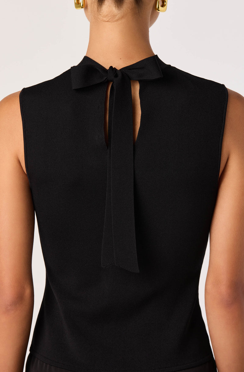 Black sleeveless top with a bow tie at the neckline.