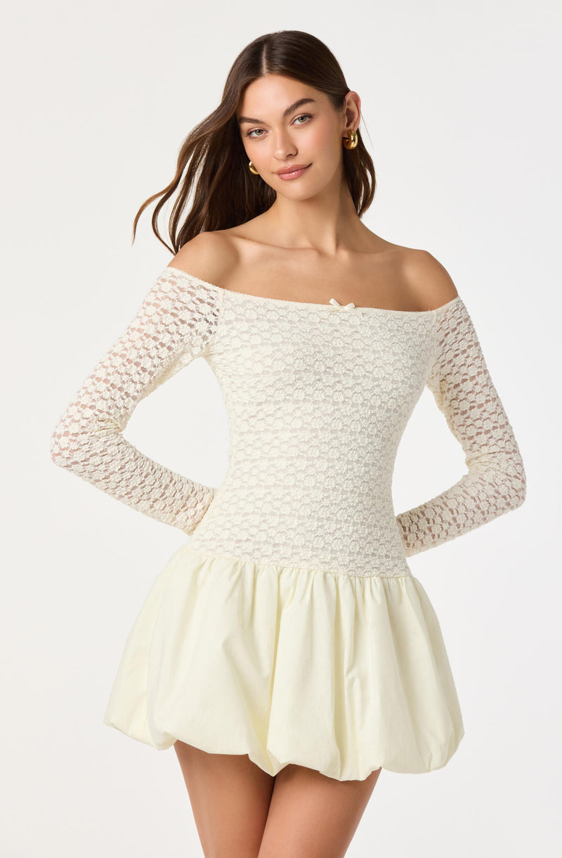 Model wearing off-the-shoulder cream lace top and cream puffed skirt.