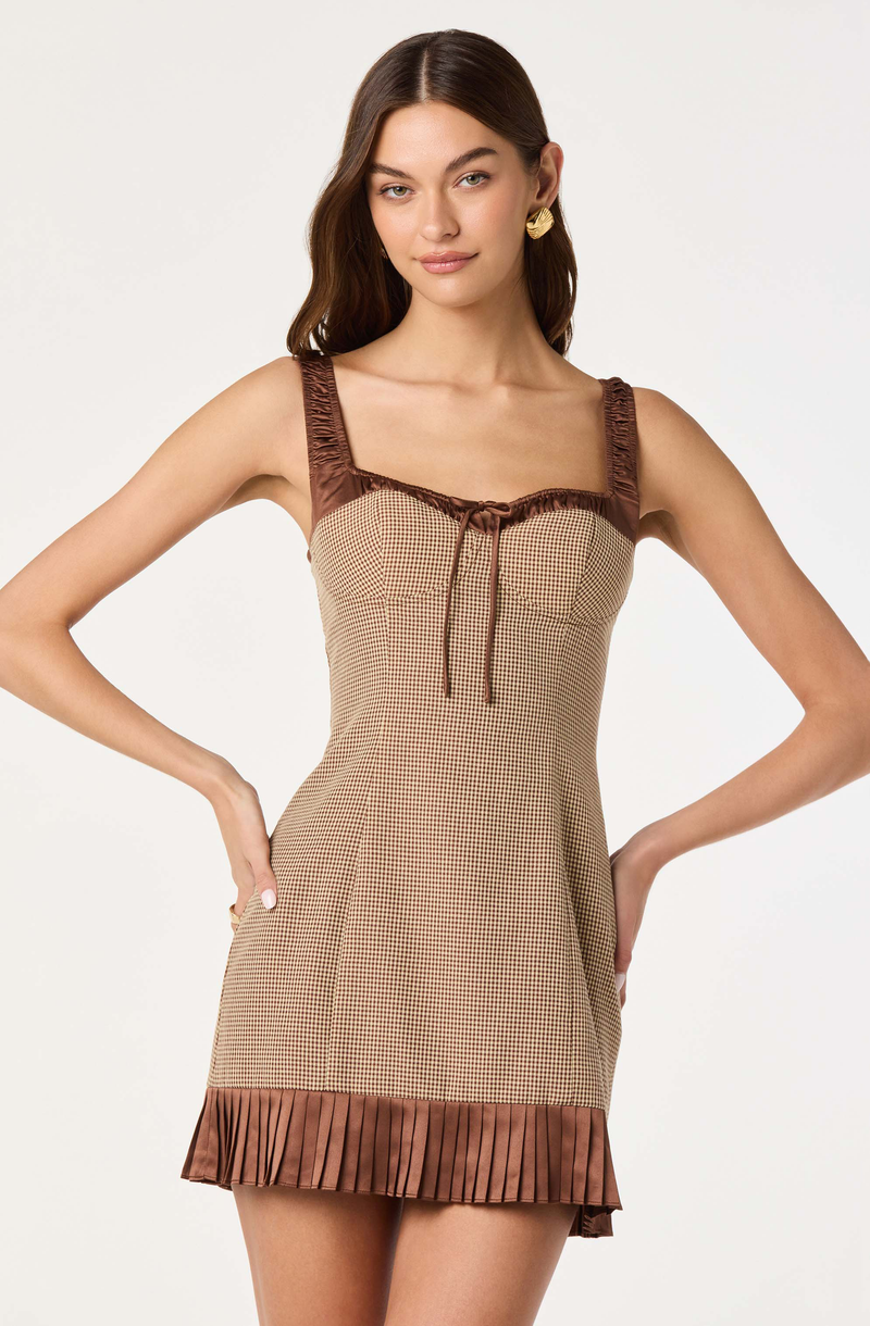 Sleeveless dress with brown plaid fabric, brown satin ruffle straps, and a pleated brown satin hem.
