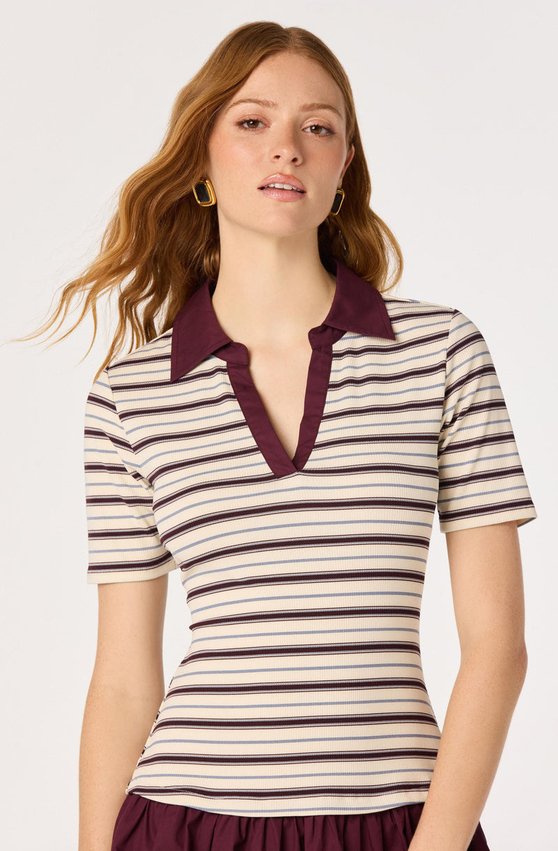 Striped short-sleeve shirt with a burgundy collar and trim, paired with earrings.