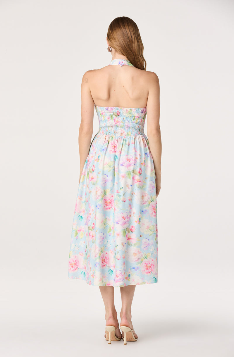 Strapless floral dress with pastel colors, fitted at the top and flowing at the hem.