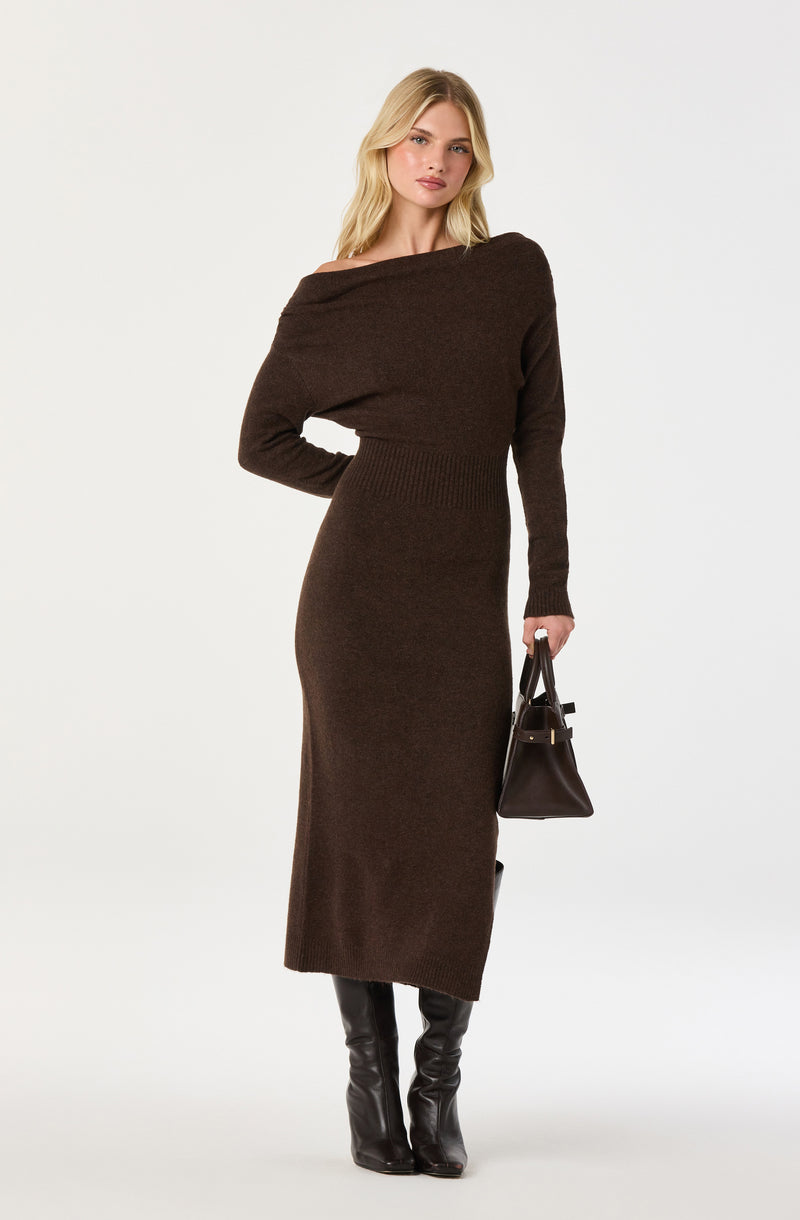 Brown off-shoulder knit dress with long sleeves and black knee-high boots, carrying a black handbag.