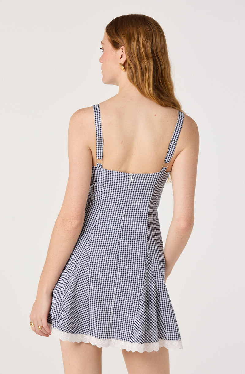 Gingham sundress with thin straps and a scalloped hem.
