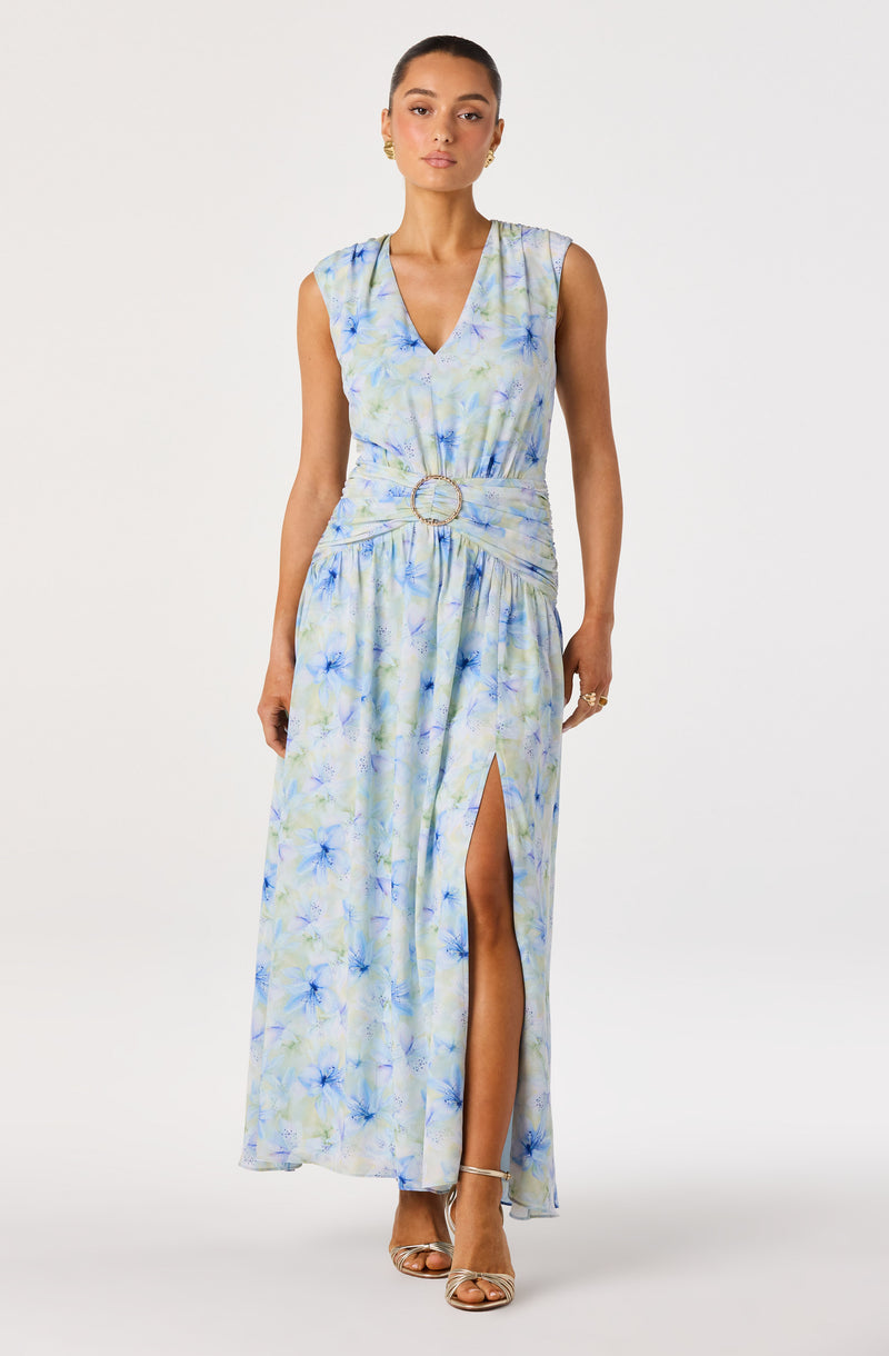 Sleeveless maxi dress in blue, green, and white tie-dye pattern with a front slit and a circular buckle waistband.