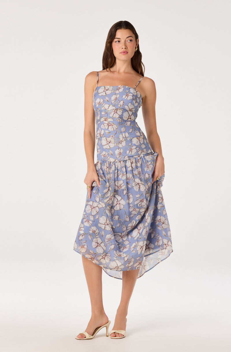 Light blue floral dress with ruffled hem and spaghetti straps.