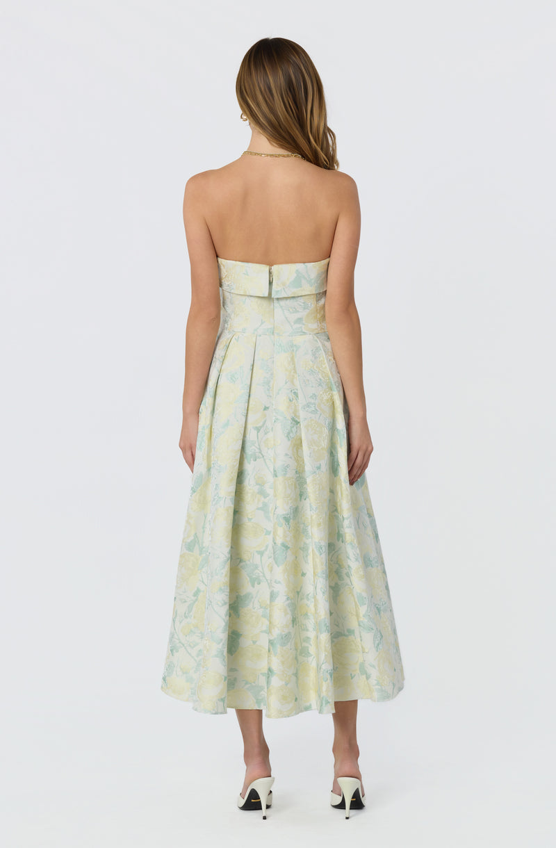 Back view of a strapless, pastel-colored floral dress with pleats and a zip closure.
