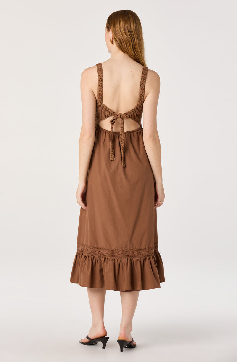 Brown sleeveless knit top with a tied back and a long brown skirt with ruffle hem.