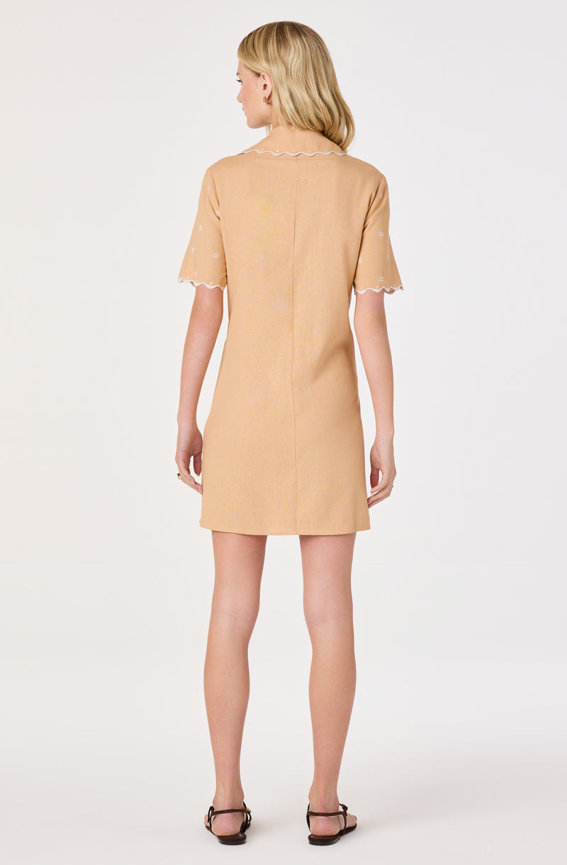 Beige knee-length dress with scalloped sleeves and collar, and delicate embroidery details.