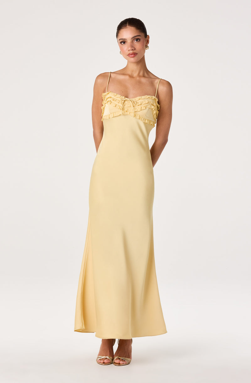 Yellow slip dress with ruffled neckline and spaghetti straps.