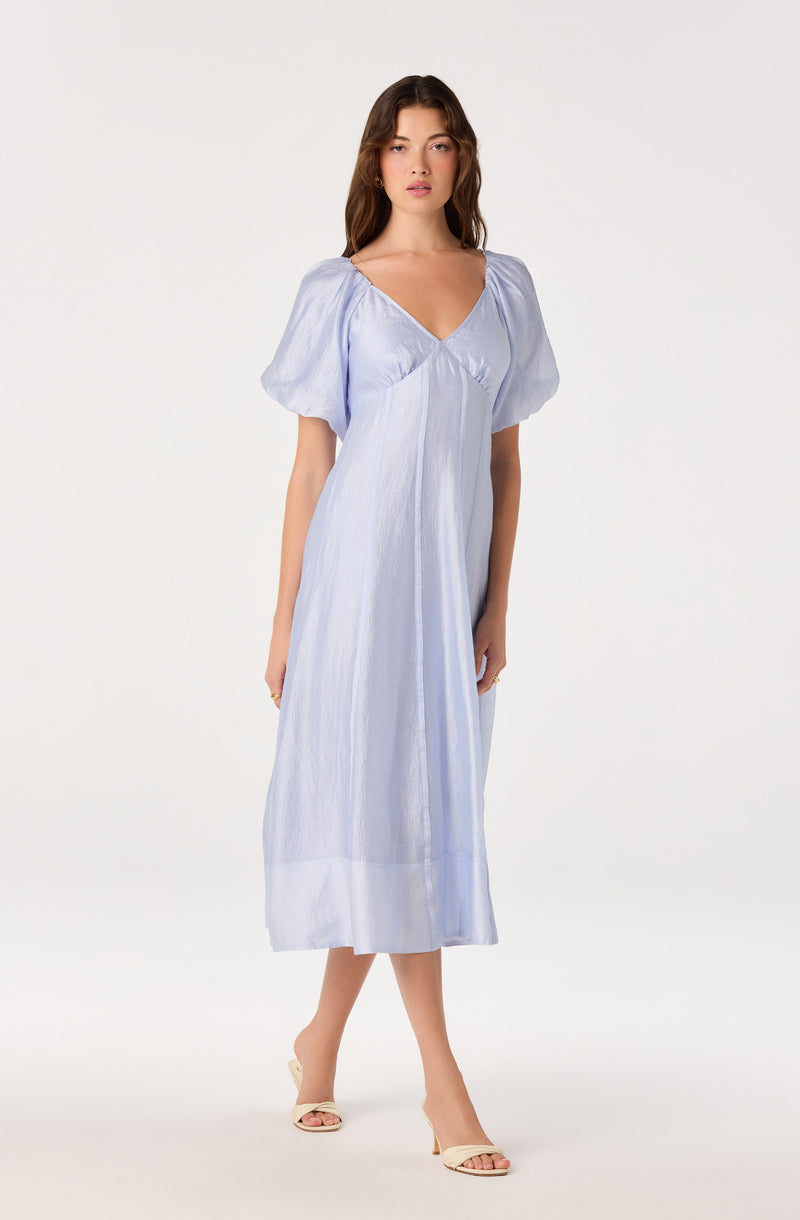 Light blue midi dress with puff sleeves and a V-neck, made of shiny, textured fabric.