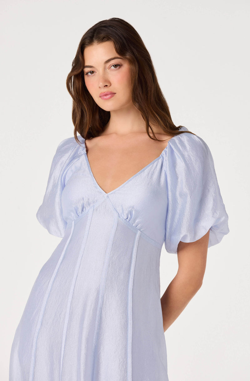 Light purple dress with puffed short sleeves and a V-neckline.