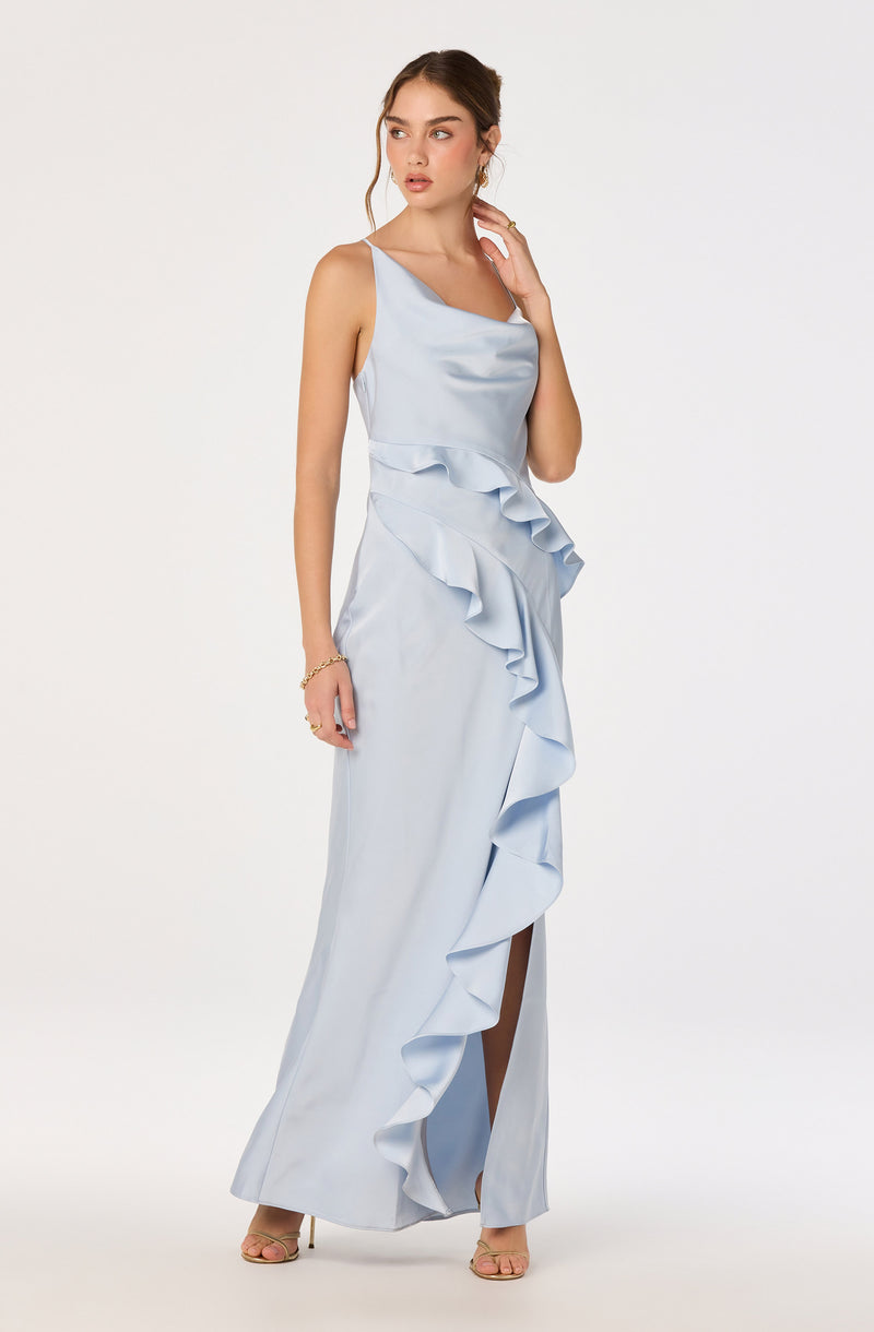 Woman in a light blue satin dress with ruffles and a thigh-high slit.