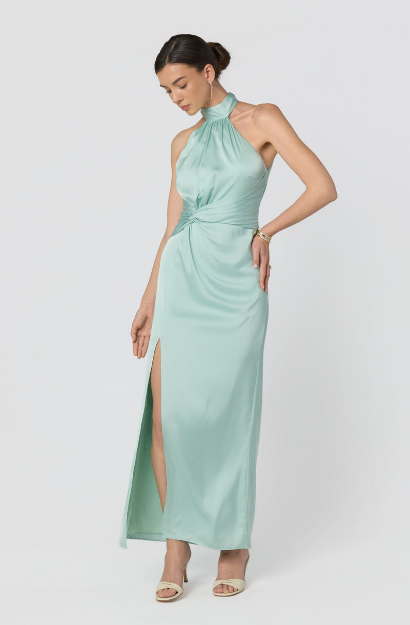 Mint green halter neck satin evening gown with side slit and gathered waist.