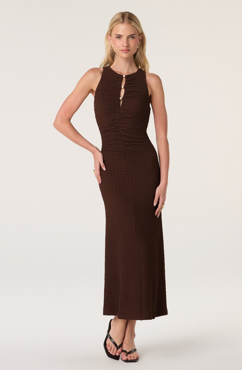 Long brown knit dress with keyhole and button details at the neckline, sleeveless style.
