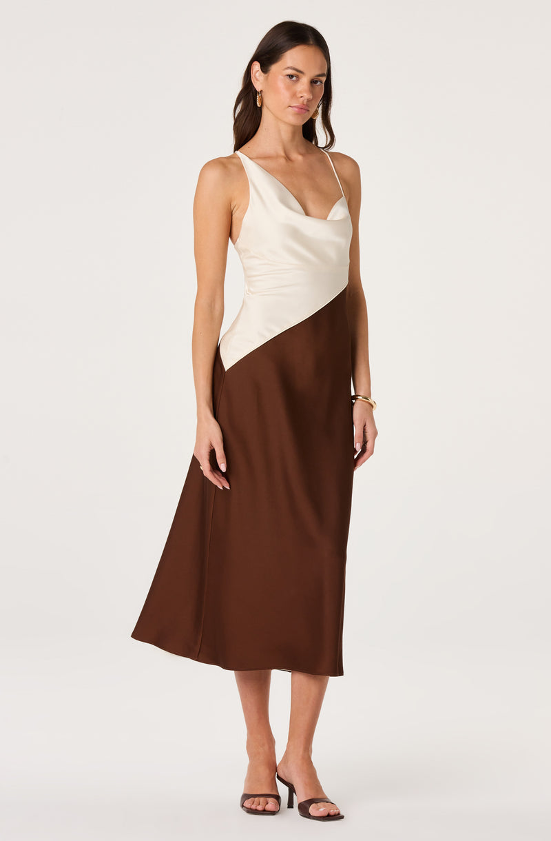 Woman in a sleeveless, color-block satin dress with spaghetti straps, ivory top, and brown skirt.