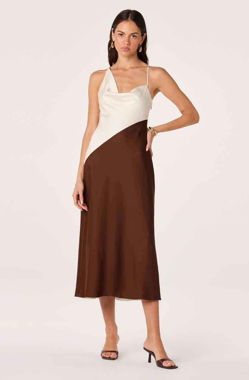 Woman wearing a color-block satin slip dress with spaghetti straps, cream on top and brown below.