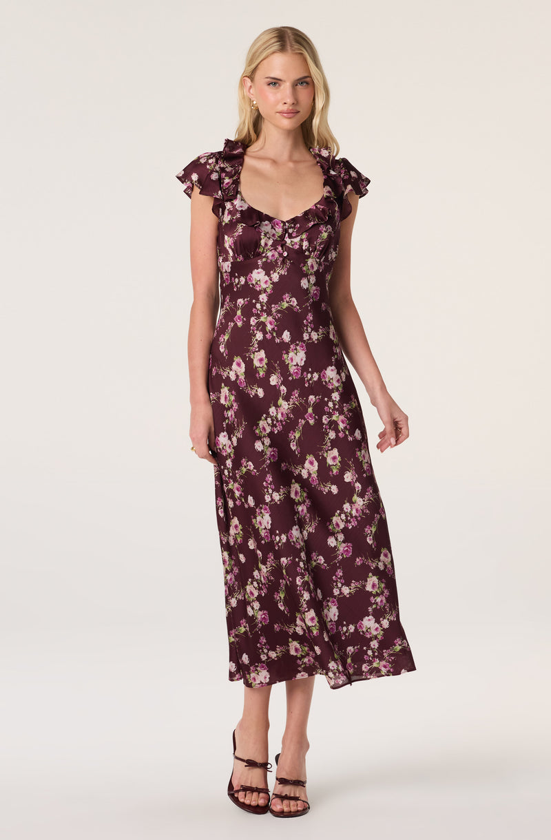 Dress with ruffled cap sleeves, deep neckline, floral print in pink and green on a deep purple background.