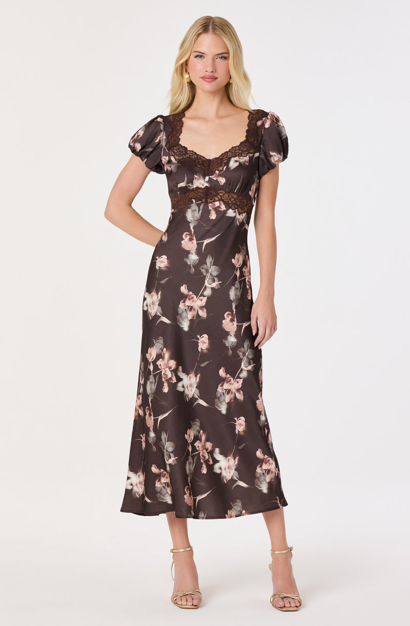 Black floral dress with puffed short sleeves and lace details at the neckline and waist.