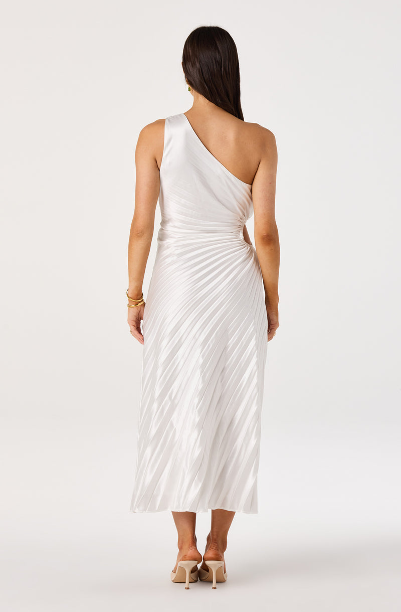 Woman in a white, pleated, one-shoulder maxi dress, facing away.
