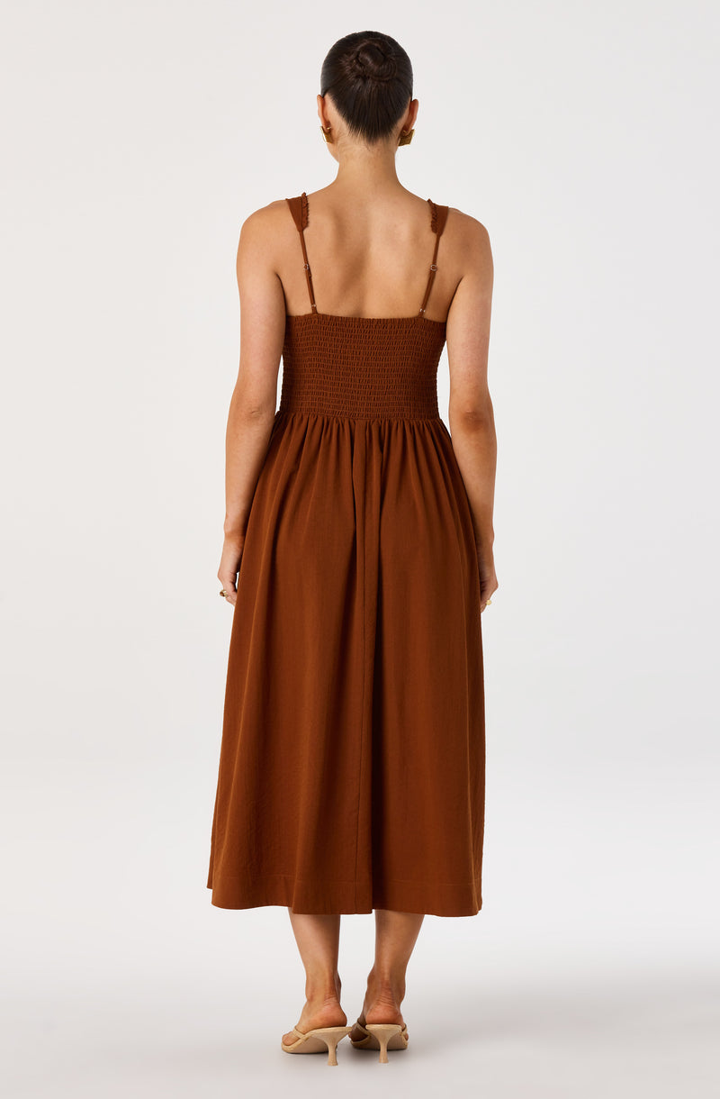 Brown sleeveless jumpsuit with thin straps and wide-leg pants.