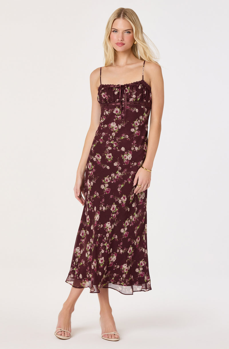 Long burgundy floral dress with spaghetti straps and ruffled neckline.