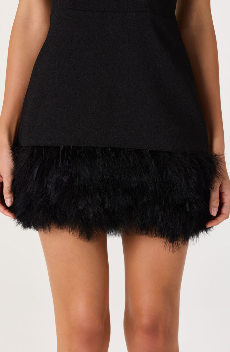 Black dress with a fur hem at the bottom.