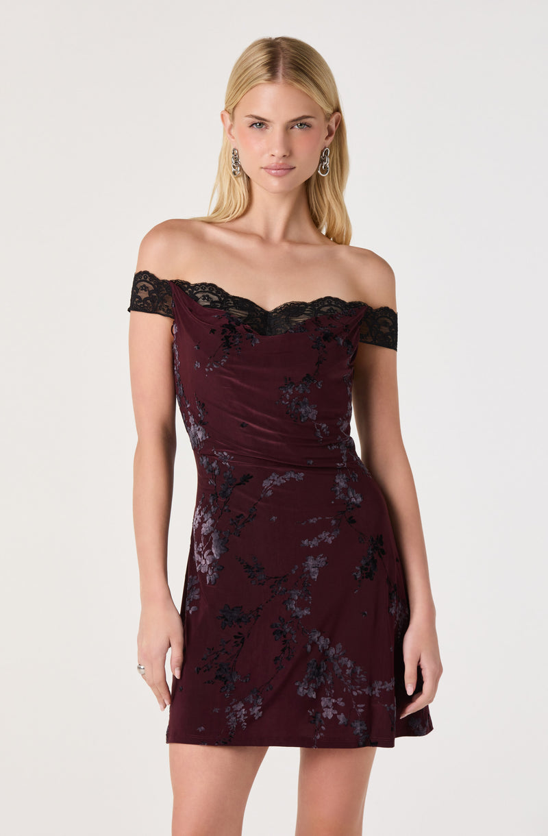 Off-shoulder burgundy dress with black lace accents and floral patterns.
