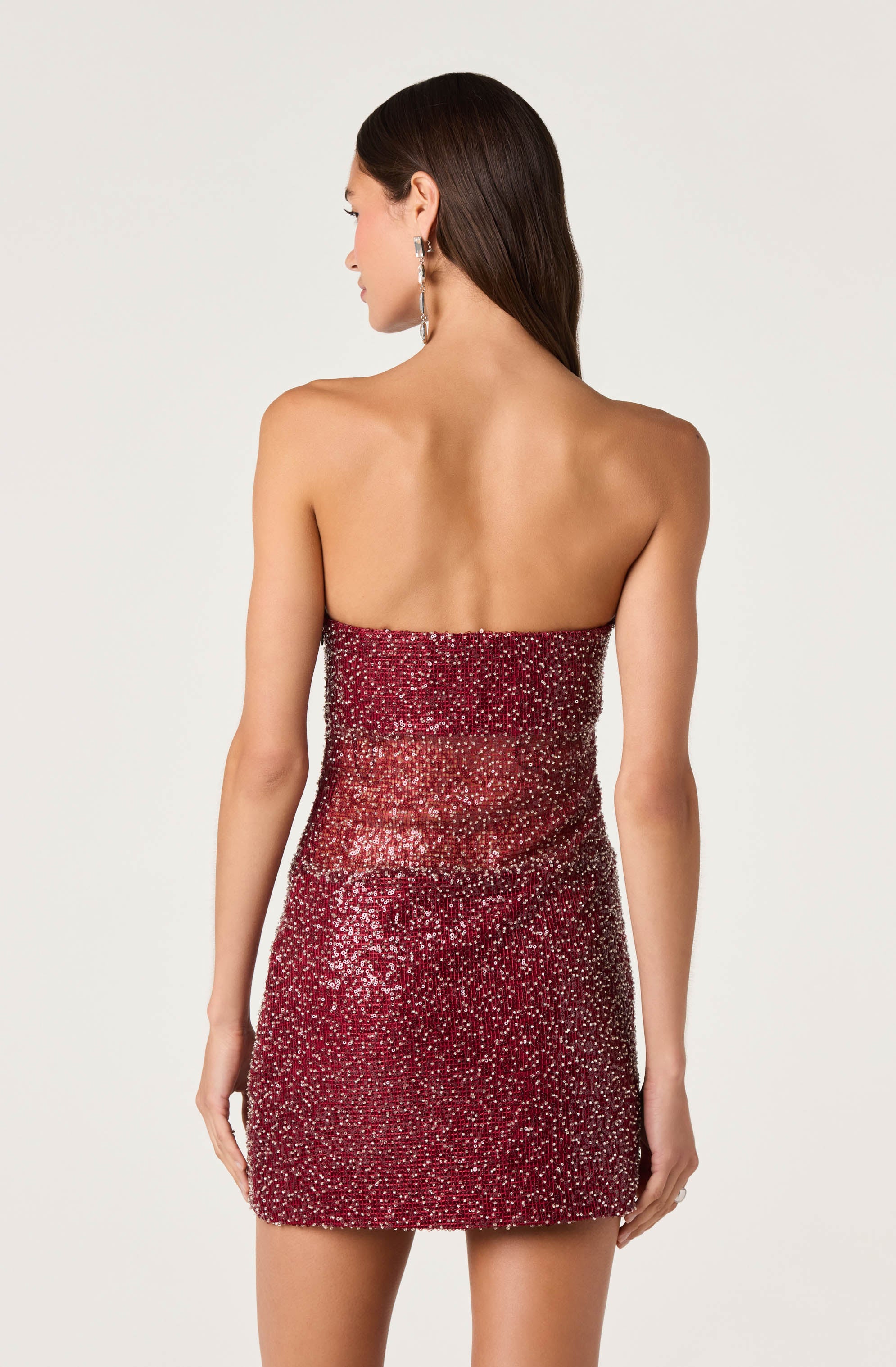 Strapless red dress with silver and white sequins, fitted style, no visible shoes.