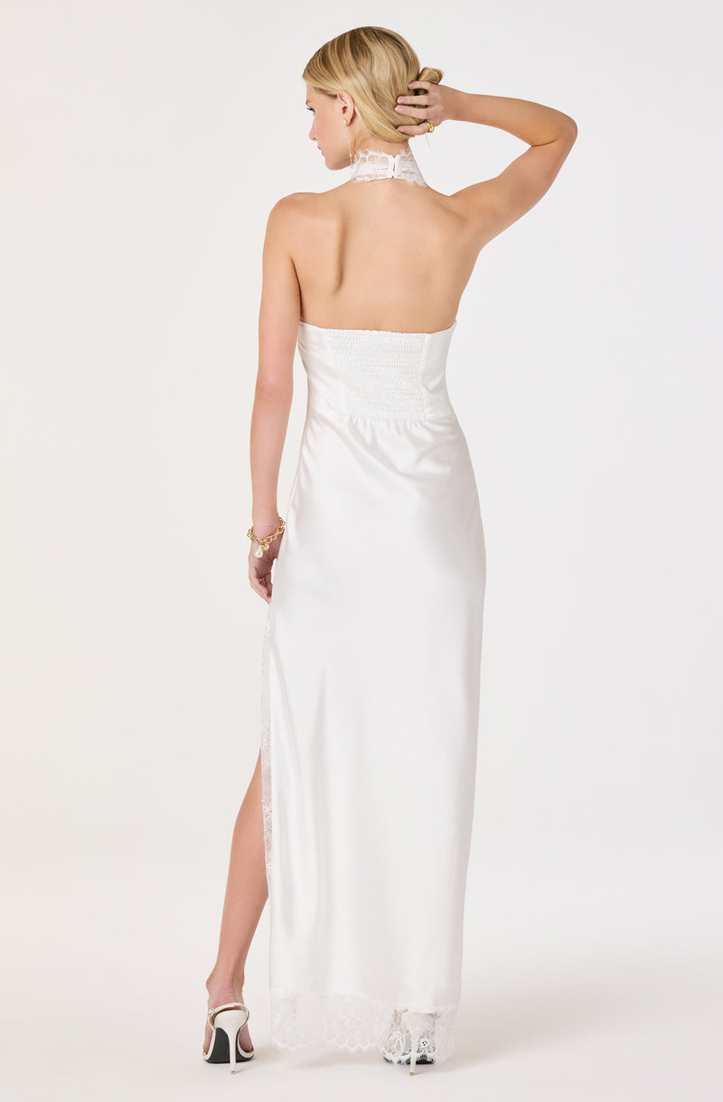 Woman in white strapless satin dress with lace details, high slit, and lace trim at the hem.