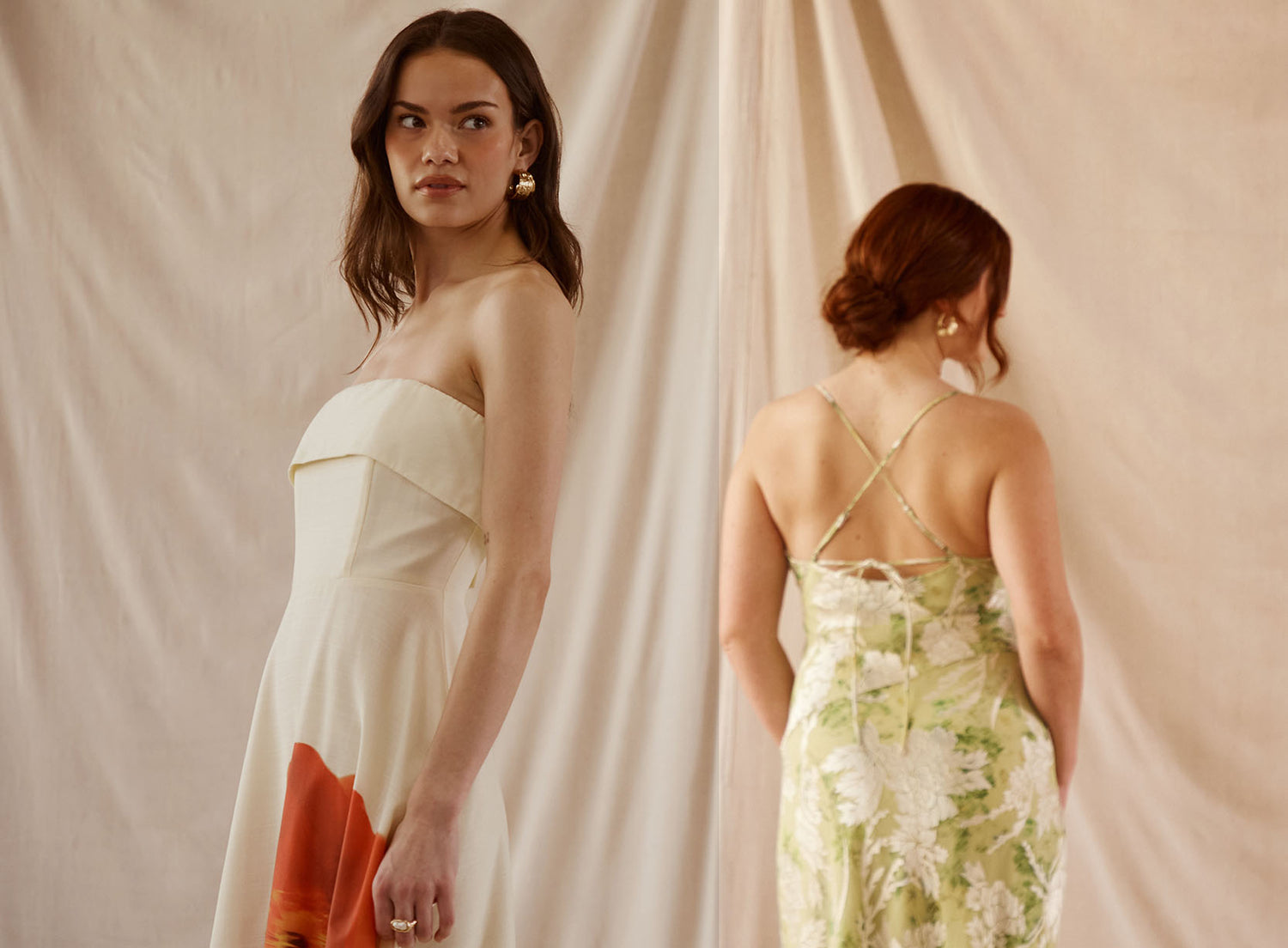 Woman in a strapless cream dress with orange floral design and another woman in a green floral slip dress with spaghetti straps.