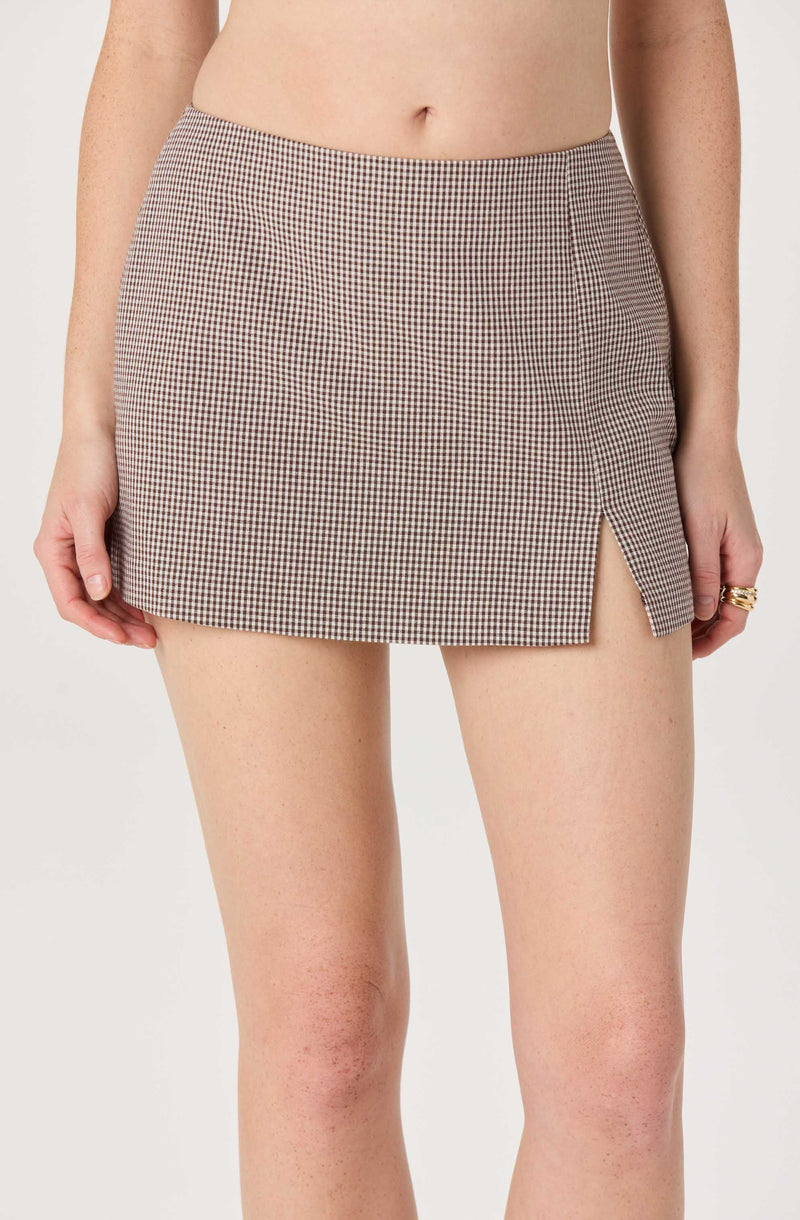 Brown and white checkered mini skirt with a side slit.