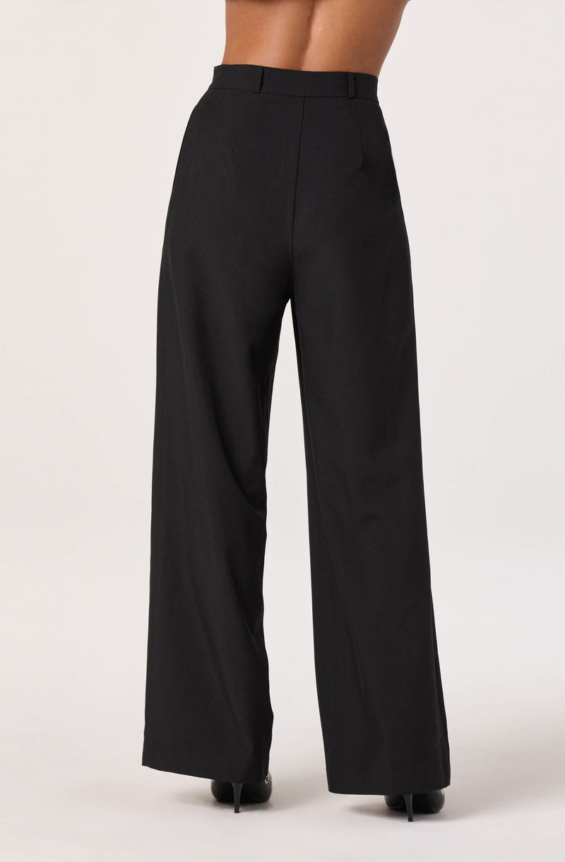 Black wide-leg dress pants with a high waist, belt loops, and a smooth front. The fabric appears shiny and drapes loosely to the floor, covering the shoes.