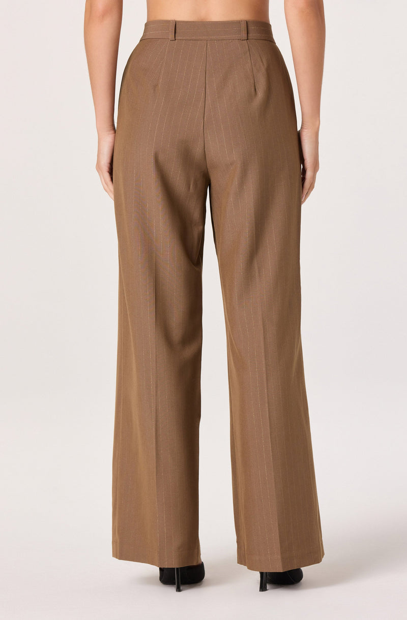The pants are high-waisted, straight-leg trousers in a light brown color with subtle vertical pinstripes. They feature belt loops, pleats at the front, and are slightly loose-fitting. The fabric has a smooth, structured appearance.