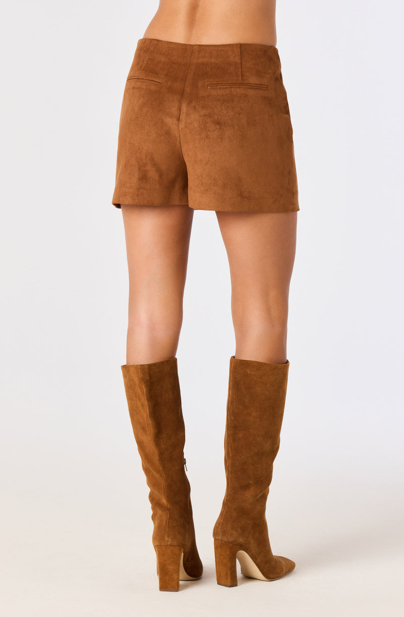 Brown suede shorts and matching knee-high boots.