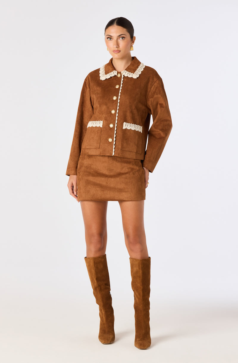 Brown jacket with pearl buttons, white lace trim, and matching brown knee-high boots.