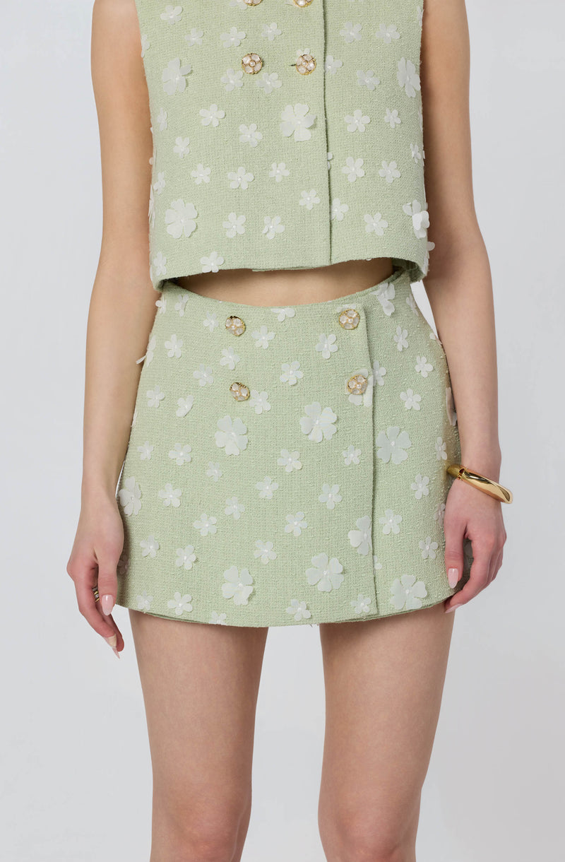 Light green floral patterned sleeveless top and matching mini skirt.