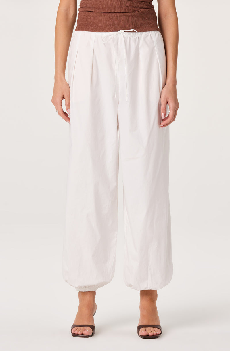 White wide-leg pants with elastic cuffs and a drawstring waist.