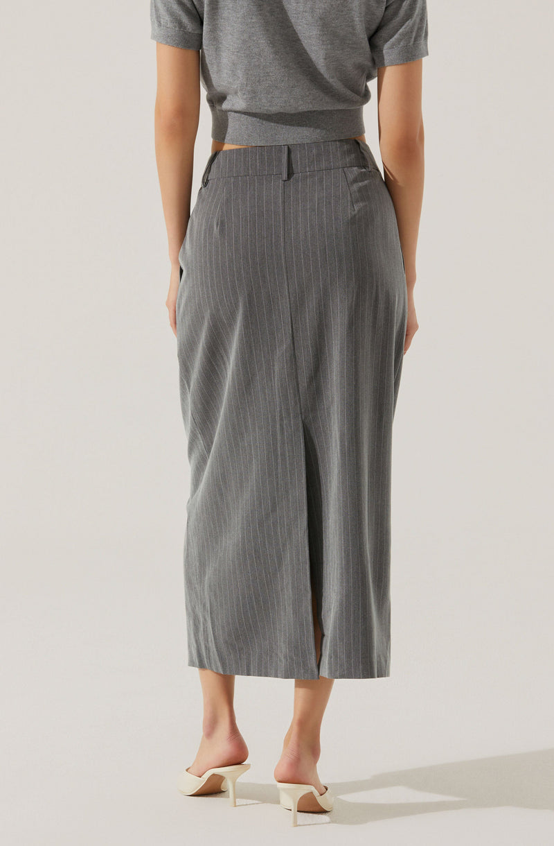 A person is wearing a pair of high-waisted, wide-leg gray trousers with thin vertical pinstripes. The trousers have belt loops at the waistband, side pockets, and a front slit at the hem. The person is also wearing a loose-fitting, short-sleeved gray top that is cropped at the waist, and cream-colored open-toe heeled shoes.