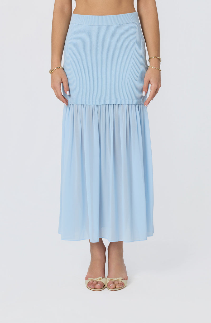 Light blue ribbed and pleated midi skirt with a tiered, flowing hem.