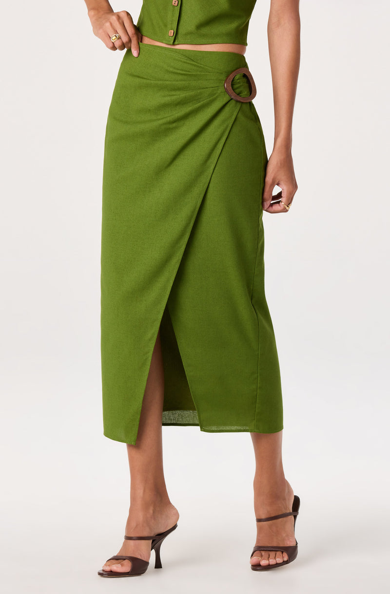 Green midi skirt with a front slit and a circular buckle detail on the waist.