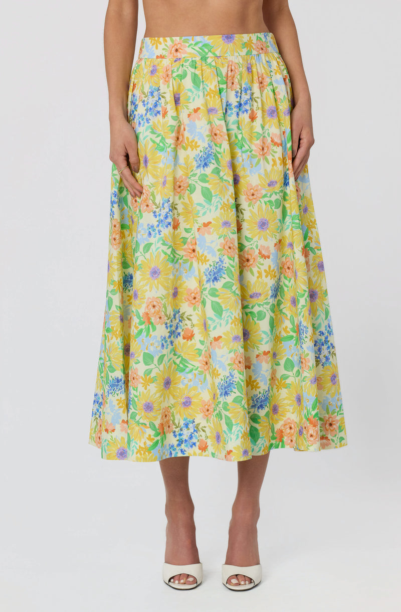 Long floral skirt with yellow, orange, purple, blue, and green patterns, high waist.