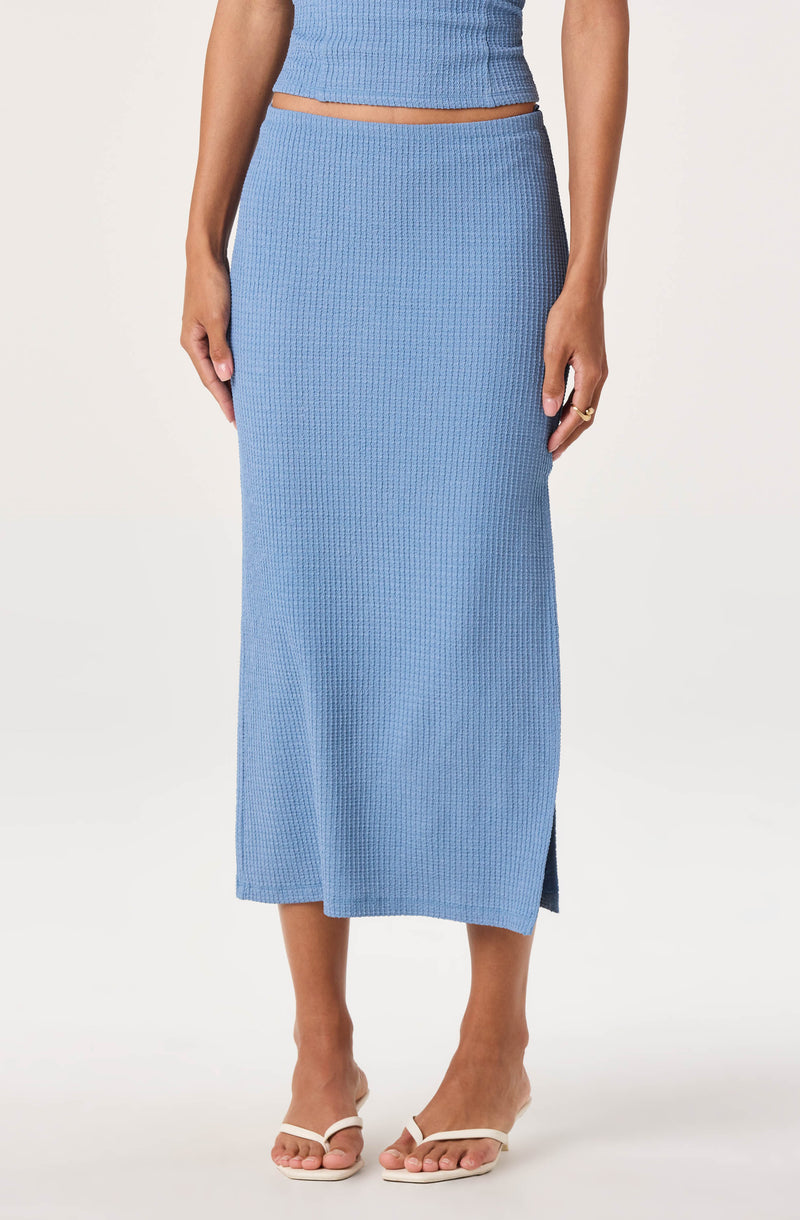 Light blue textured knit skirt with a side slit, paired with a matching crop top.