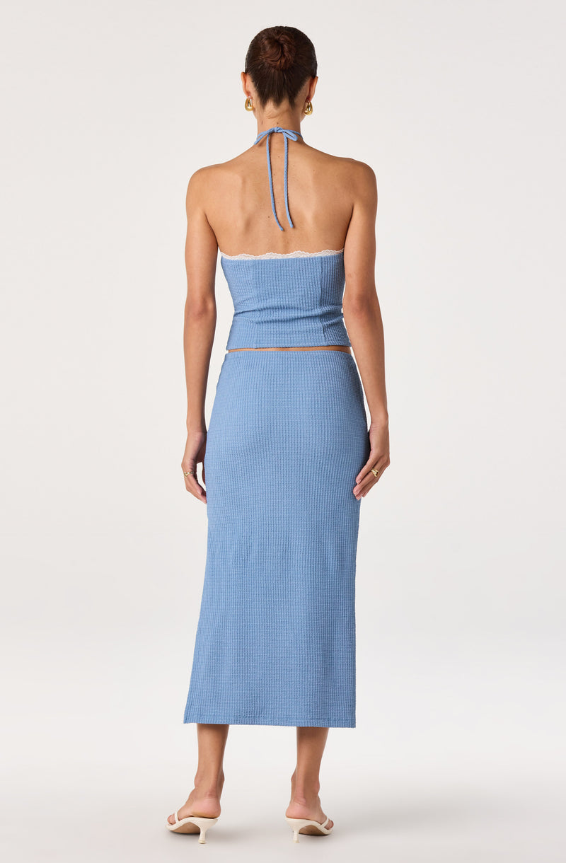 Light blue halter crop top and matching high-waisted skirt.