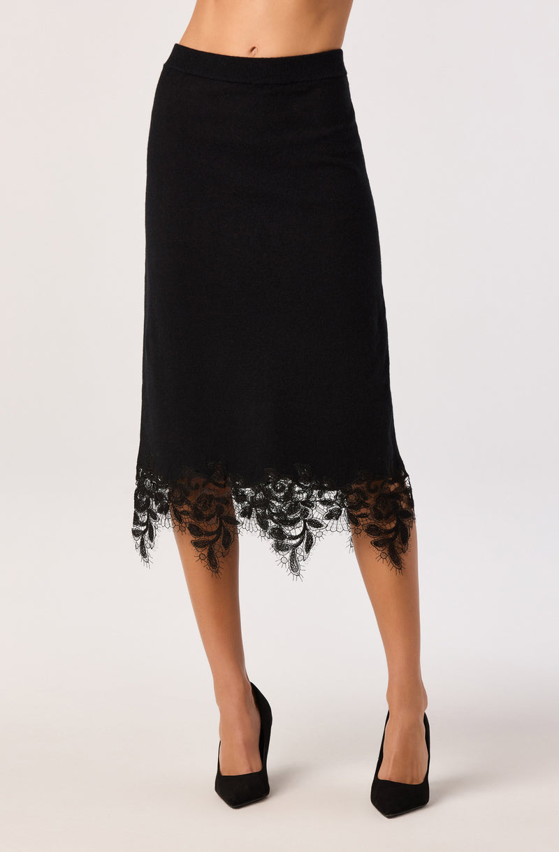 Black midi skirt with lace hem, paired with black heels.