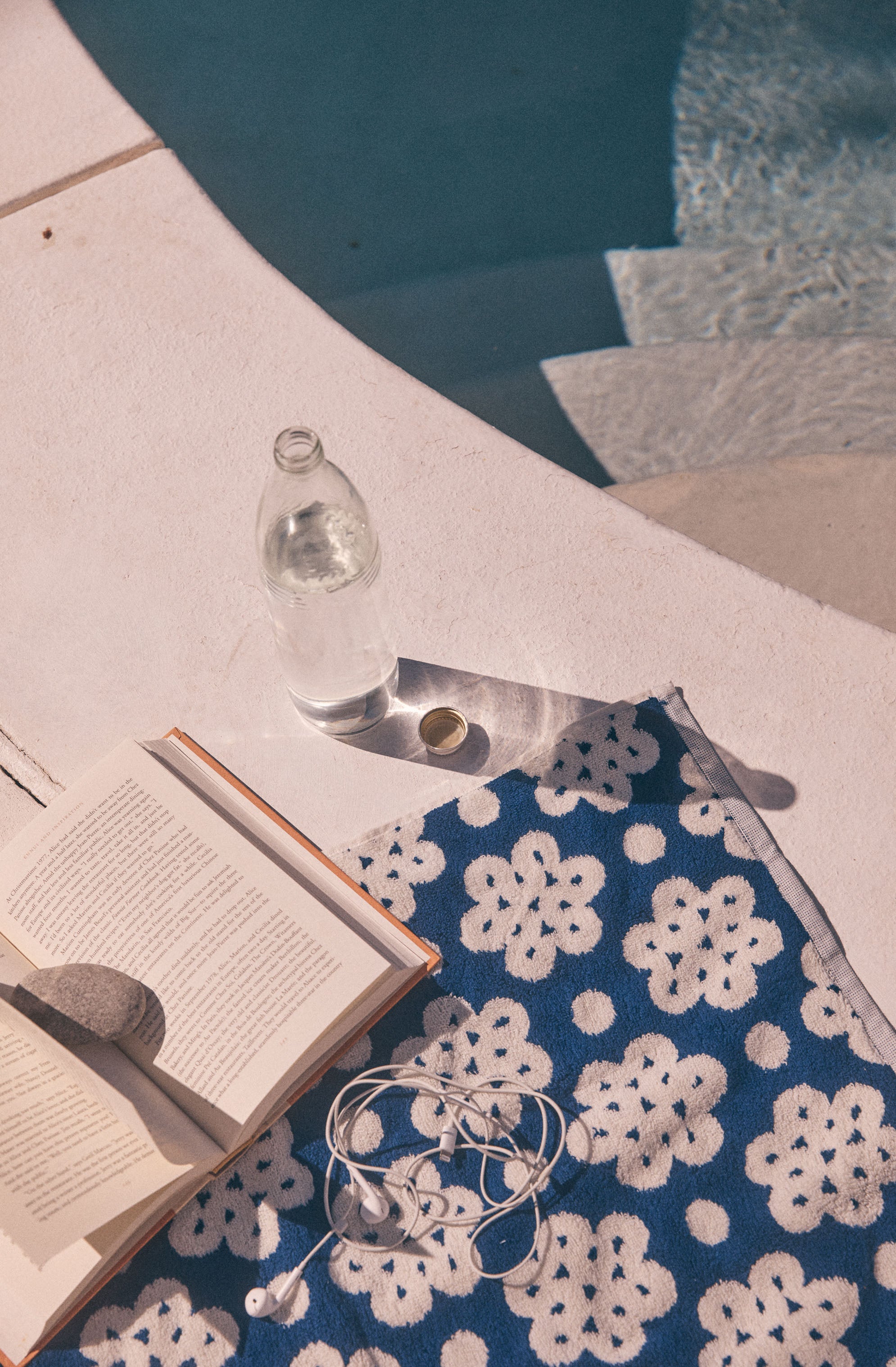 Clothing with a blue and white floral pattern, partially visible edge, on a pink surface.