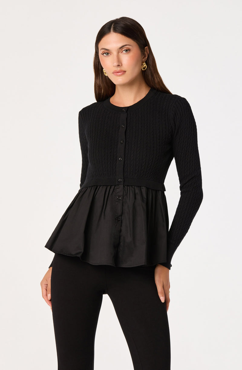 Black long-sleeve top with a cable-knit pattern and a peplum-style satin hem.