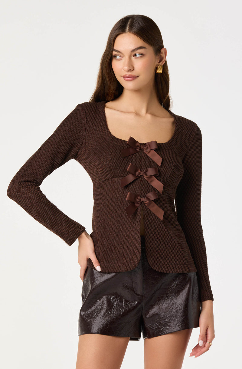 Brown textured long-sleeve top with brown bows down the front.