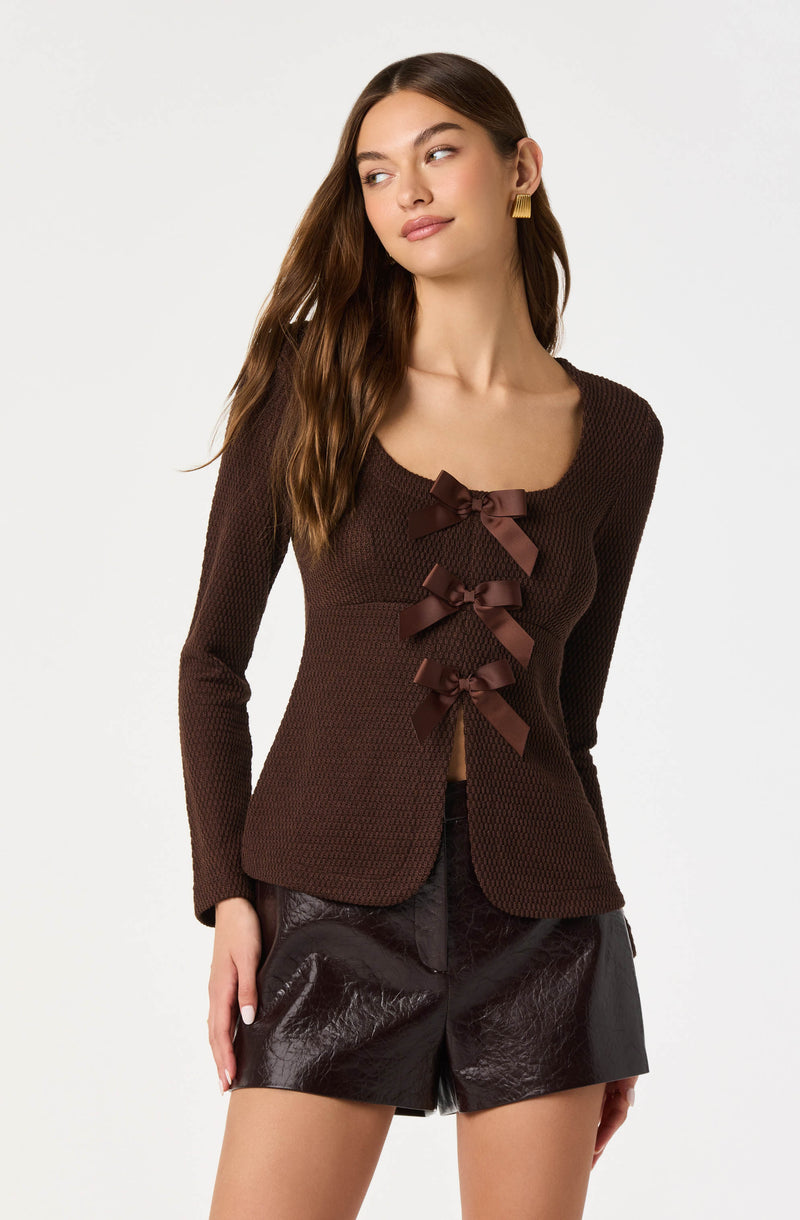 Brown textured blazer with three satin bows down the front.