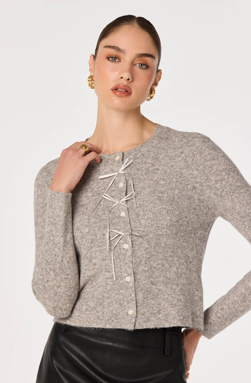 Gray knit cardigan with lace-up front and pearl buttons.