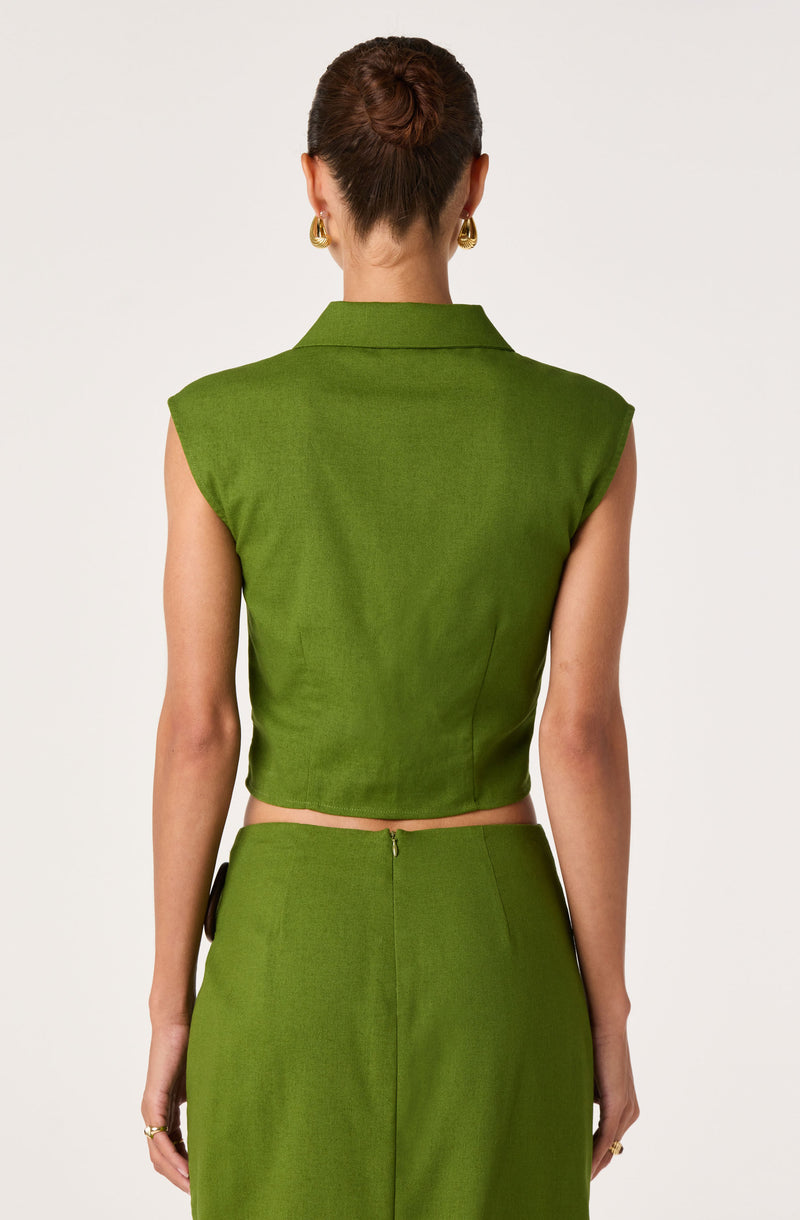 Back view of woman in a sleeveless green top and matching skirt.